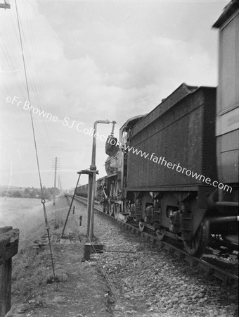 TRAIN PASSES DANGLING MAILBAG